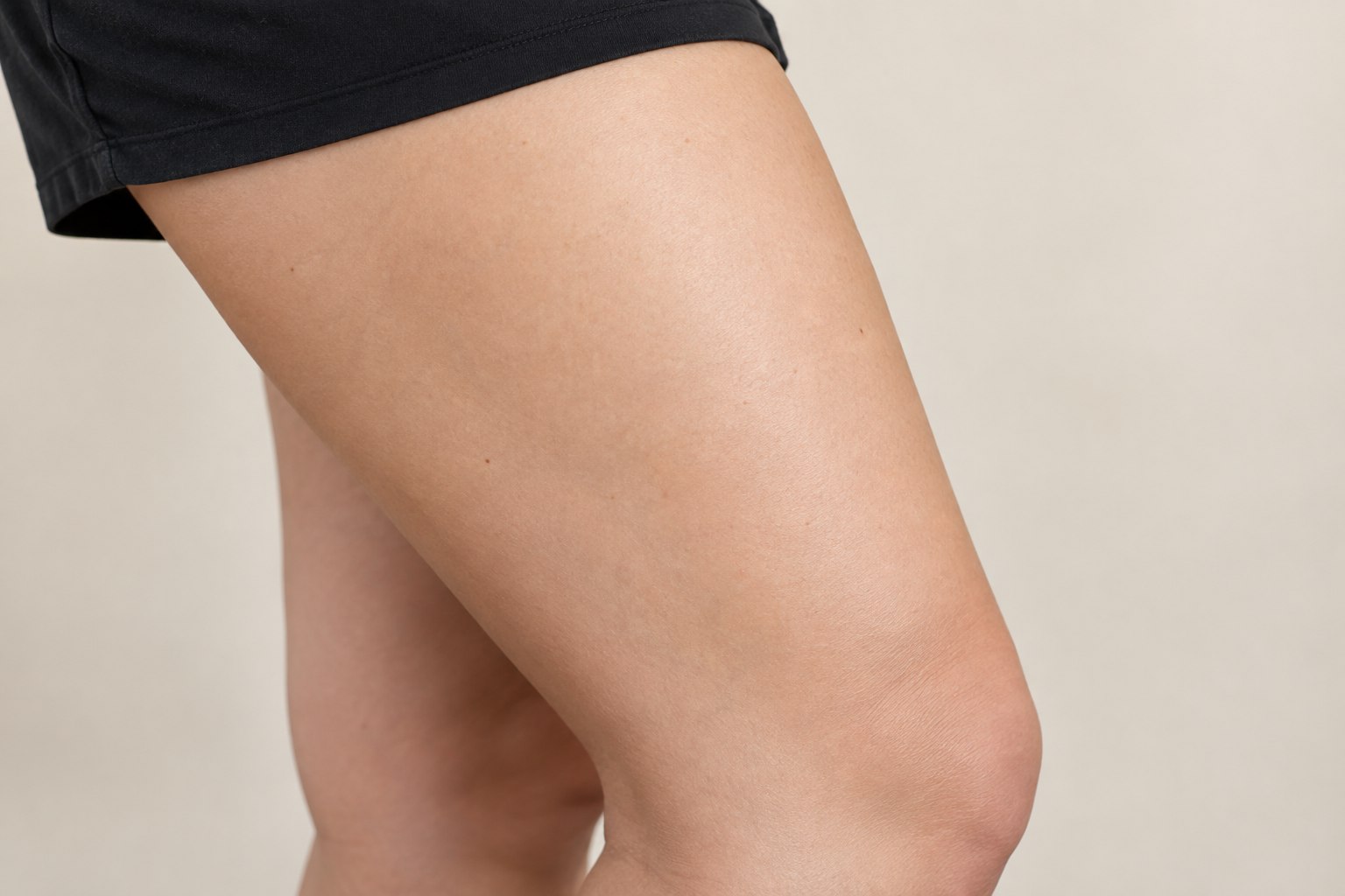 Thigh and Leg placement reference, female adult AI model, no tattoo applied